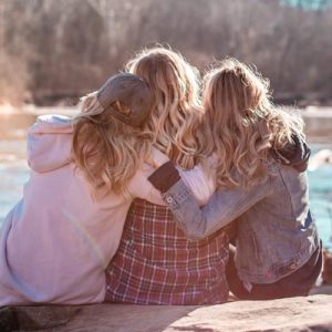 Three friends hugging