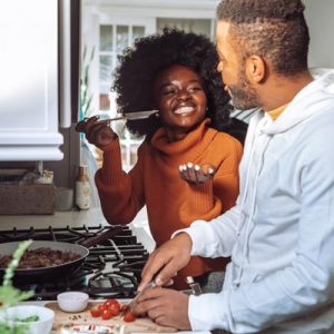 A couple cooking together 